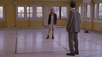 Movie still from “The Object of My Affection” (1998), directed by Nicholas Hytner – A man and a woman standing in an empty room; Wide shot, High angle