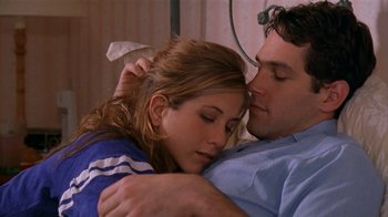 Movie still from “The Object of My Affection” (1998), directed by Nicholas Hytner – A man and a woman embracing in a hospital bed; Close Up shot, High angle