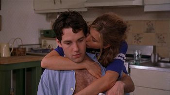 Movie still from “The Object of My Affection” (1998), directed by Nicholas Hytner – A man and a woman are hugging in a kitchen; Medium shot, Over the shoulder angle