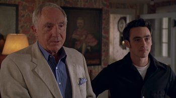 Movie still from “The Object of My Affection” (1998), directed by Nicholas Hytner – A man standing next to another man in front of a painting; Medium shot, Over the shoulder angle