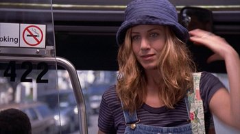 Movie still from “The Object of My Affection” (1998), directed by Nicholas Hytner – A woman with a hat is standing on a bus; Close Up shot, High angle