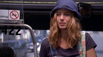 Movie still from “The Object of My Affection” (1998), directed by Nicholas Hytner – A woman in a hat is riding a bus; Close Up shot, High angle
