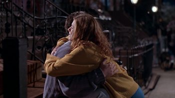 Movie still from “The Object of My Affection” (1998), directed by Nicholas Hytner – Two people hugging each other in a dark room; Medium shot, Over the shoulder angle