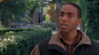 Movie still from “The Object of My Affection” (1998), directed by Nicholas Hytner – A man in a brown and black jacket looking to his left; Close Up shot, High angle
