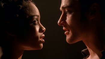 Movie still from “The Object of My Affection” (1998), directed by Nicholas Hytner – A man and a woman looking at each other in the dark; Close Up shot, Low angle