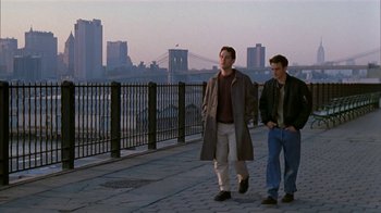 Movie still from “The Object of My Affection” (1998), directed by Nicholas Hytner – Two men walking down a sidewalk in front of a city; Wide shot, Low angle
