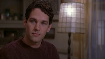 Movie still from “The Object of My Affection” (1998), directed by Nicholas Hytner – A man in a brown sweater sitting in front of a lamp; Close Up shot, Over the shoulder angle