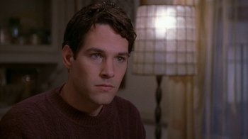 Movie still from “The Object of My Affection” (1998), directed by Nicholas Hytner – A young man in a sweater stares into the camera; Close Up shot, Over the shoulder angle