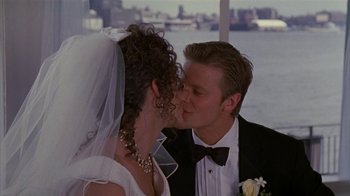 Movie still from “The Object of My Affection” (1998), directed by Nicholas Hytner – A man and woman kissing on a boat; Close Up shot, High angle