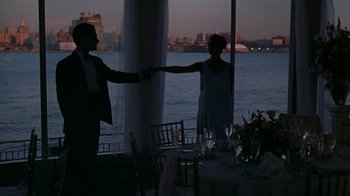 Movie still from “The Object of My Affection” (1998), directed by Nicholas Hytner – A man and a woman standing in front of a window; Wide shot, Over the shoulder angle