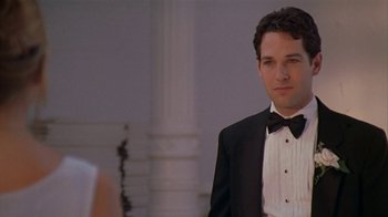 Movie still from “The Object of My Affection” (1998), directed by Nicholas Hytner – A man in a tuxedo standing in front of a woman; Medium shot, Over the shoulder angle