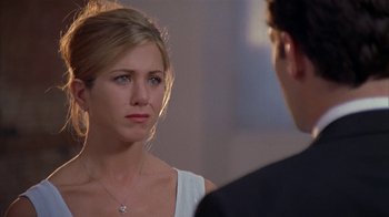 Movie still from “The Object of My Affection” (1998), directed by Nicholas Hytner – A woman is looking at a man in a suit; Close Up shot, Over the shoulder angle