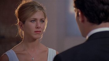 Movie still from “The Object of My Affection” (1998), directed by Nicholas Hytner – A woman is looking at a man in a suit; Close Up shot, Over the shoulder angle