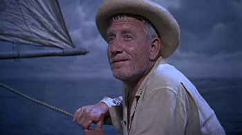 Movie still from “The Old Man and the Sea” (1958), directed by Fred Zinnemann – An older man wearing a straw hat while holding a rope; Close Up shot, Low angle