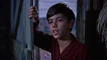 Movie still from “The Old Man and the Sea” (1958), directed by Fred Zinnemann – A young boy in a red shirt is holding a pole; Close Up shot, High angle