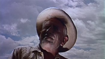 Movie still from “The Old Man and the Sea” (1958), directed by Fred Zinnemann – An old man wearing a cowboy hat in front of a cloudy sky; Close Up shot, Low angle