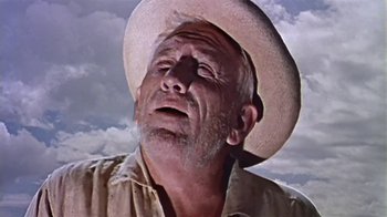 Movie still from “The Old Man and the Sea” (1958), directed by Fred Zinnemann – An old man wearing a cowboy hat looking up; Close Up shot, Low angle