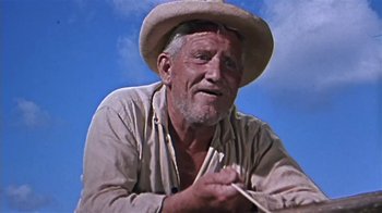 Movie still from “The Old Man and the Sea” (1958), directed by Fred Zinnemann – An older man wearing a cowboy hat while sitting on the ground; Close Up shot, Low angle
