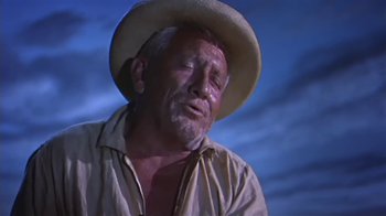 Movie still from “The Old Man and the Sea” (1958), directed by Fred Zinnemann – An older man wearing a hat and a shirt; Close Up shot, Low angle