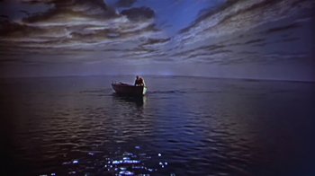 Movie still from “The Old Man and the Sea” (1958), directed by Fred Zinnemann – Two people in a boat in the middle of the ocean; Extreme Wide shot, High angle