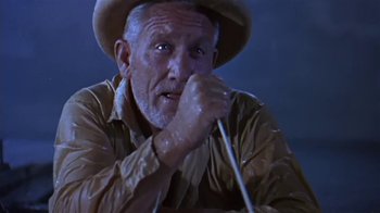 Movie still from “The Old Man and the Sea” (1958), directed by Fred Zinnemann – An old man wearing a cowboy hat and holding a whip; Close Up shot, Low angle