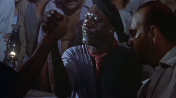 Movie still from “The Old Man and the Sea” (1958), directed by Fred Zinnemann – A man with a black hat is looking up at the sky; Close Up shot, High angle
