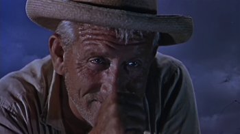 Movie still from “The Old Man and the Sea” (1958), directed by Fred Zinnemann – An older man wearing a cowboy hat with his hand on his face; Close Up shot, Low angle