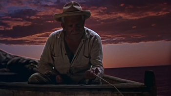Movie still from “The Old Man and the Sea” (1958), directed by Fred Zinnemann – An old man sitting in a boat on the water; Medium shot, Low angle