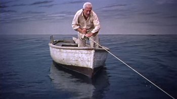 Movie still from “The Old Man and the Sea” (1958), directed by Fred Zinnemann – An old man is in a boat in the water; Wide shot, Low angle