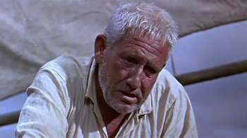 Movie still from “The Old Man and the Sea” (1958), directed by Fred Zinnemann – An older man with white hair looking at the camera; Close Up shot, Low angle