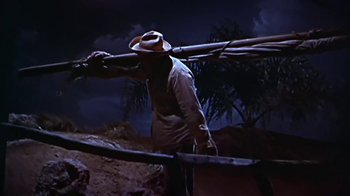 Movie still from “The Old Man and the Sea” (1958), directed by Fred Zinnemann – A man in a hat is holding a pole; Wide shot, Low angle