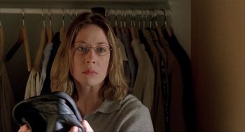 Movie still from “The One and Only” (1999), directed by Susanne Bier – A woman in glasses looking at the camera; Close Up shot, Over the shoulder angle