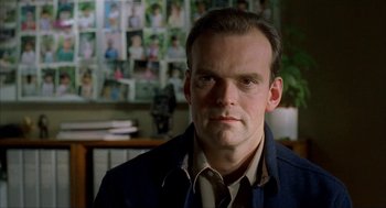 Movie still from “The One and Only” (1999), directed by Susanne Bier – A person wearing a suit and tie; Close Up shot, Low angle