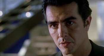 Movie still from “The One and Only” (1999), directed by Susanne Bier – A man's face in a dark room; Close Up shot, Low angle