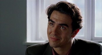 Movie still from “The One and Only” (1999), directed by Susanne Bier – A person wearing a suit and tie; Close Up shot, Over the shoulder angle