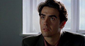 Movie still from “The One and Only” (1999), directed by Susanne Bier – A man that is sitting in a room; Close Up shot, Over the shoulder angle