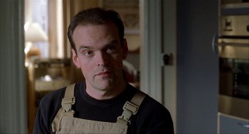 Movie still from “The One and Only” (1999), directed by Susanne Bier – A person with a beard wearing an overalls; Close Up shot, Low angle