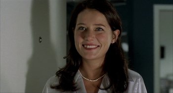 Movie still from “The One and Only” (1999), directed by Susanne Bier – A woman wearing a white shirt and a pearl necklace; Close Up shot, Low angle