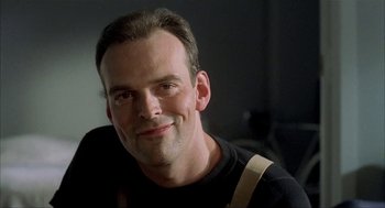Movie still from “The One and Only” (1999), directed by Susanne Bier – A person smiling for the camera; Close Up shot, Low angle