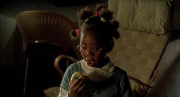 Movie still from “The One and Only” (1999), directed by Susanne Bier – A little girl is eating a piece of fruit; Close Up shot, High angle