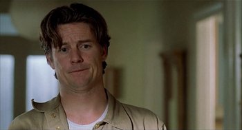 Movie still from “The One and Only” (1999), directed by Susanne Bier – A person wearing a tan shirt; Close Up shot, Low angle