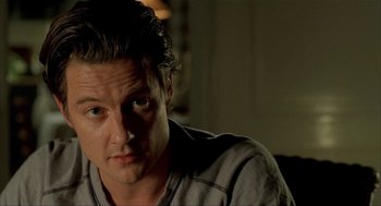 Movie still from “The One and Only” (1999), directed by Susanne Bier – A person sitting in a room; Close Up shot, High angle