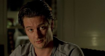 Movie still from “The One and Only” (1999), directed by Susanne Bier – A person sitting in front of a window; Close Up shot, High angle