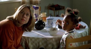 Movie still from “The One and Only” (1999), directed by Susanne Bier – A woman sitting at a table with a child; Close Up shot, Over the shoulder angle