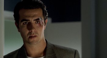 Movie still from “The One and Only” (1999), directed by Susanne Bier – A person wearing a suit and eye patch; Close Up shot, Low angle