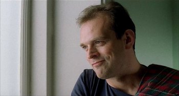 Movie still from “The One and Only” (1999), directed by Susanne Bier – A person sitting in front of a window; Close Up shot, Low angle