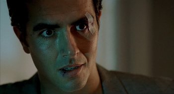 Movie still from “The One and Only” (1999), directed by Susanne Bier – A person with a bandage on his eye; Close Up shot, Over the shoulder angle