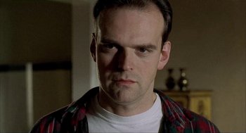 Movie still from “The One and Only” (1999), directed by Susanne Bier – A person wearing a plaid shirt; Close Up shot, Low angle