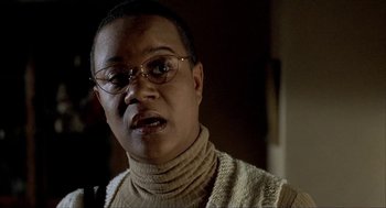 Movie still from “The One and Only” (1999), directed by Susanne Bier – An older woman wearing glasses and a sweater; Close Up shot, Low angle