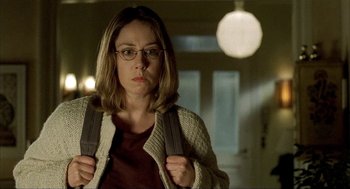 Movie still from “The One and Only” (1999), directed by Susanne Bier – A woman with glasses is holding a backpack; Close Up shot, Low angle